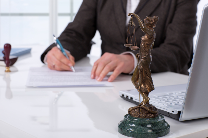 Man signing contract at desk